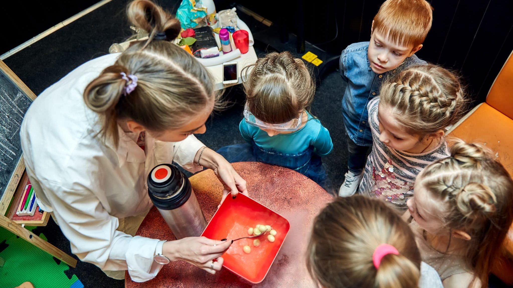 enfants regroupés autour d'une scientifique