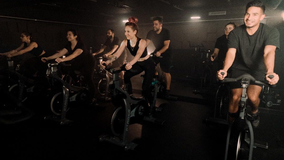 Un session d'indoor cycling en présence de Kevin, coach, à droite.