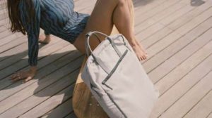 femme détendue sur terrasse bois avec sac recyclé