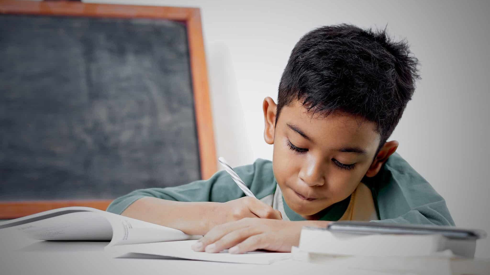 Un petit garçon fait ses devoirs. Dyslexie.