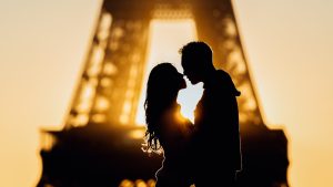 Silhouettes at sunrise in Paris, France by the Eiffel Tower